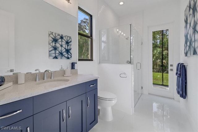 bathroom featuring a stall shower, plenty of natural light, and vanity