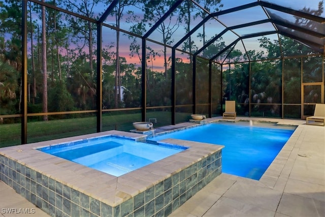 view of swimming pool with a lanai, a patio area, and a pool with connected hot tub