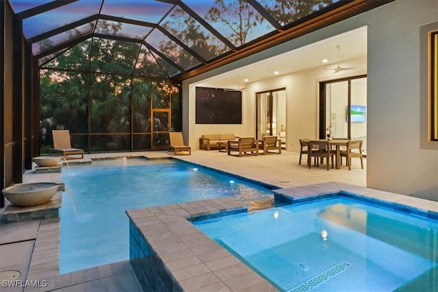 view of swimming pool with a patio area, a pool with connected hot tub, an outdoor hangout area, and ceiling fan