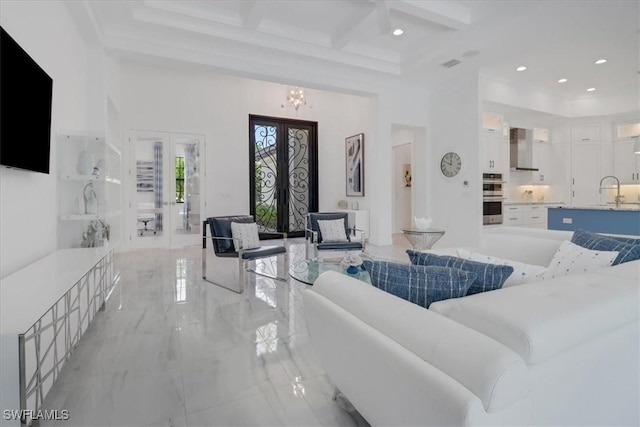 living room featuring french doors, coffered ceiling, a towering ceiling, and marble finish floor