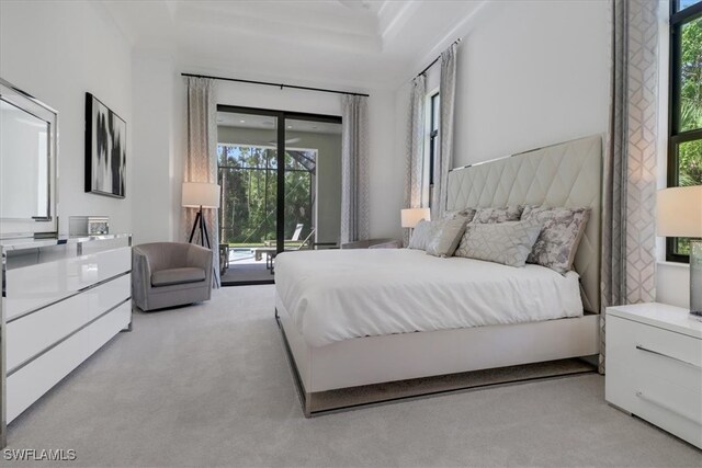 bedroom featuring light carpet and access to exterior