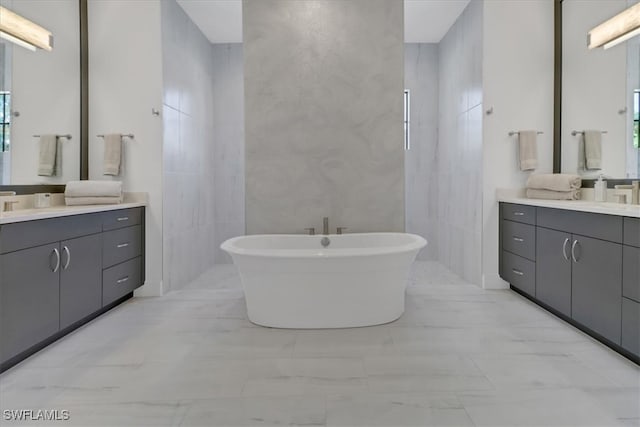 bathroom featuring a soaking tub, two vanities, tile walls, and walk in shower