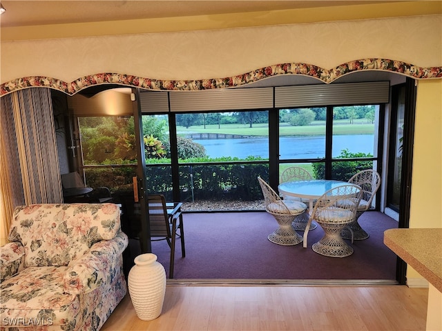 living room featuring hardwood / wood-style floors and a water view