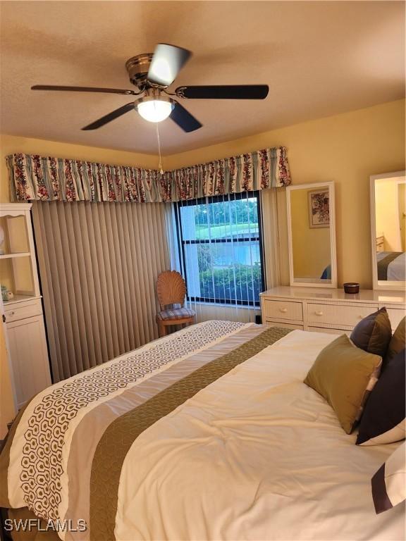 bedroom with ceiling fan and carpet