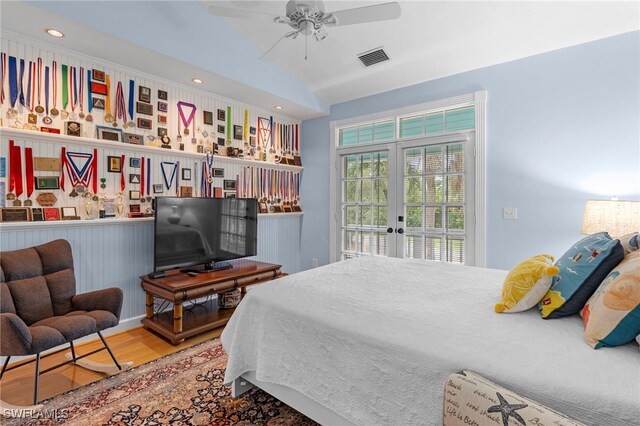 bedroom featuring ceiling fan, french doors, vaulted ceiling, and hardwood / wood-style flooring