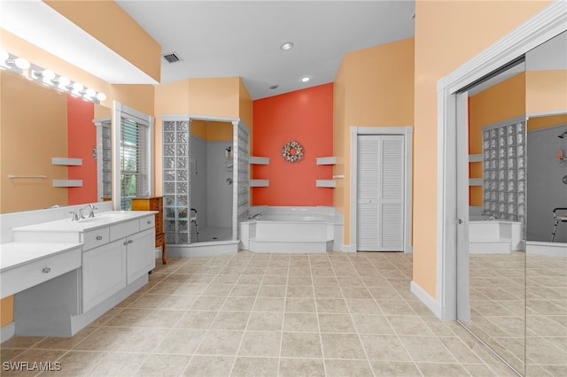 bathroom featuring tile patterned flooring, vanity, and separate shower and tub