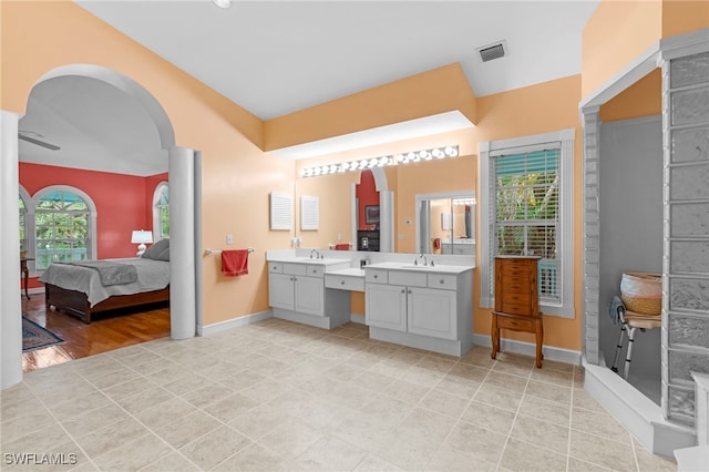 bathroom featuring tile patterned floors, ceiling fan, and vanity