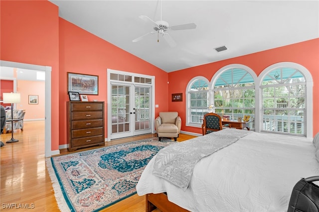 bedroom featuring hardwood / wood-style floors, high vaulted ceiling, access to outside, french doors, and ceiling fan