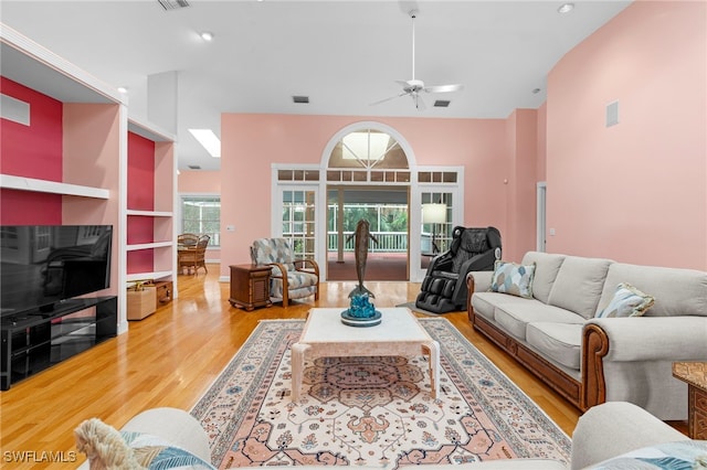 living room with hardwood / wood-style flooring and ceiling fan