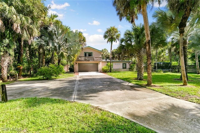 view of front of home featuring a garage and a front lawn