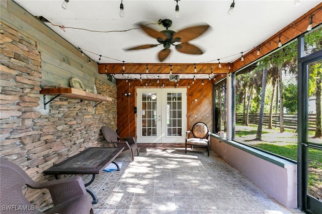 unfurnished sunroom with french doors, plenty of natural light, and ceiling fan