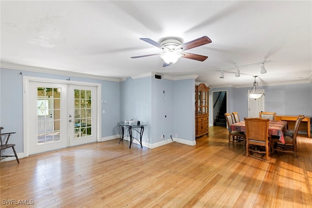 dining area featuring crown molding, french doors, light hardwood / wood-style floors, track lighting, and ceiling fan