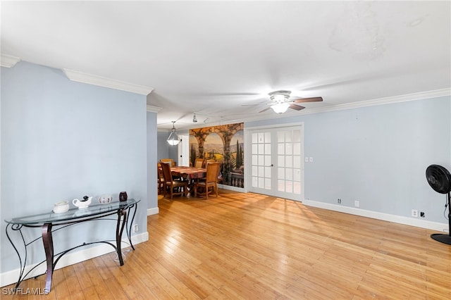 interior space featuring ornamental molding, light wood-type flooring, and french doors