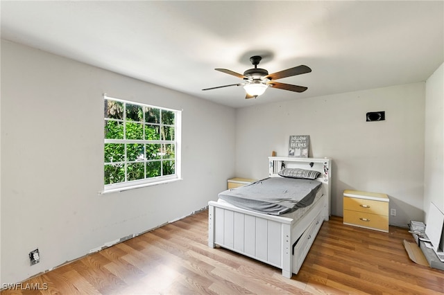 bedroom featuring light hardwood / wood-style flooring and ceiling fan