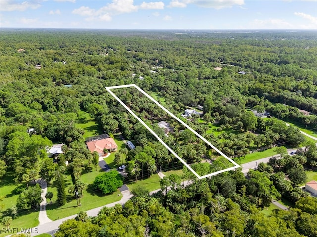 birds eye view of property featuring a wooded view