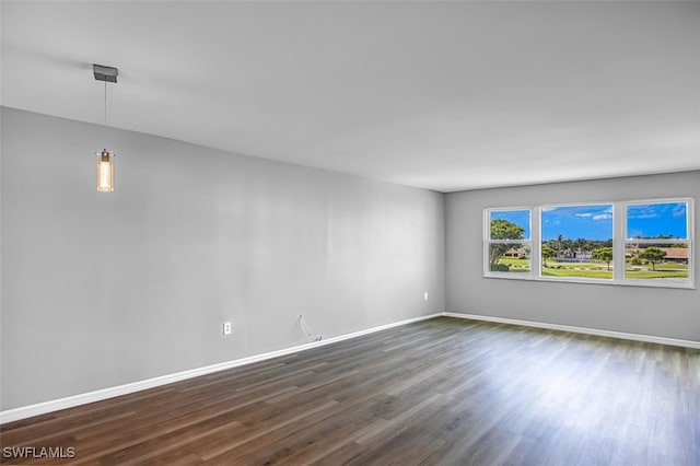 empty room with dark hardwood / wood-style floors