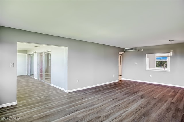 spare room with wood-type flooring