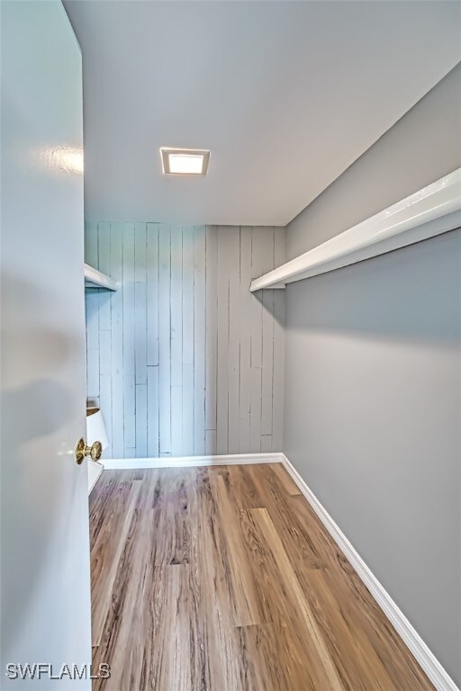 spacious closet with hardwood / wood-style flooring