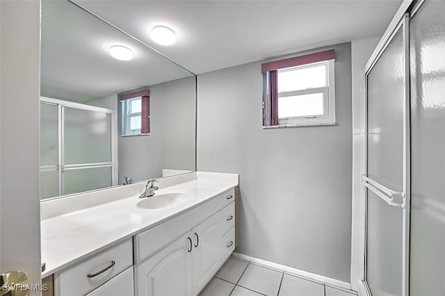 bathroom featuring tile patterned floors, vanity, and a shower with shower door