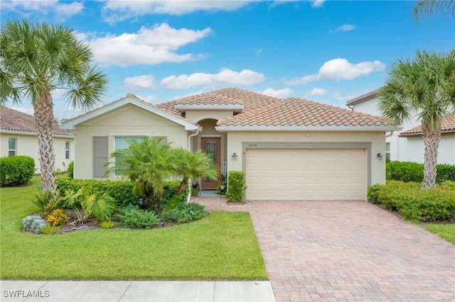 mediterranean / spanish-style house with a front yard and a garage