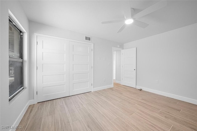 unfurnished bedroom featuring ceiling fan and a closet