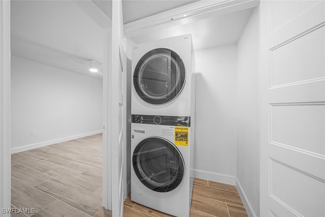 clothes washing area with stacked washer / dryer