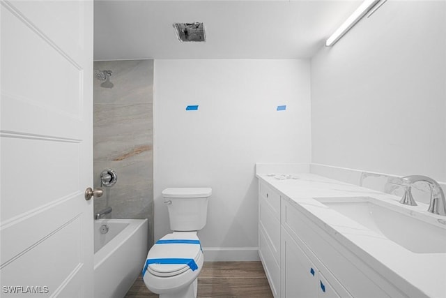 full bathroom with vanity, hardwood / wood-style flooring, toilet, and tiled shower / bath