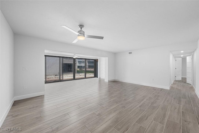 spare room featuring light hardwood / wood-style flooring and ceiling fan