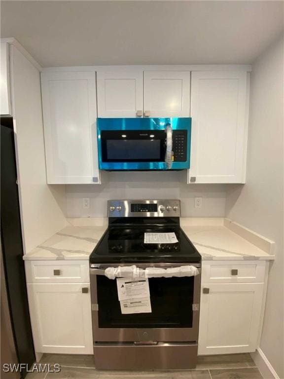 kitchen featuring appliances with stainless steel finishes and white cabinetry