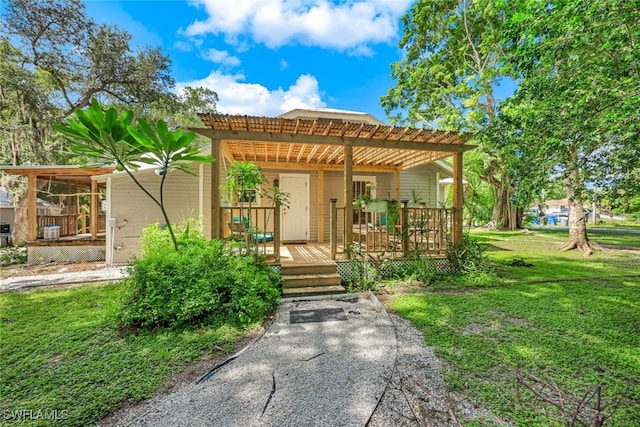 view of front of house with a pergola and a front yard