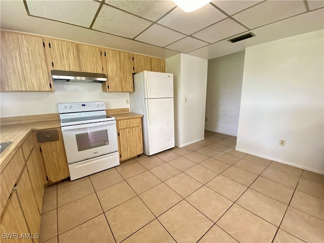 kitchen featuring a paneled ceiling, ventilation hood, light tile patterned flooring, and white appliances