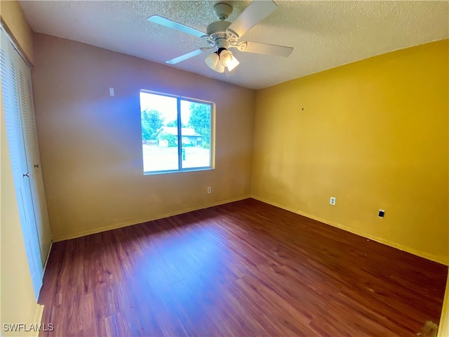 unfurnished room with ceiling fan, a textured ceiling, and wood-type flooring