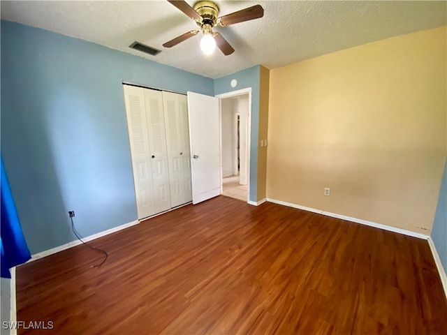 unfurnished bedroom featuring a closet, ceiling fan, and wood-type flooring