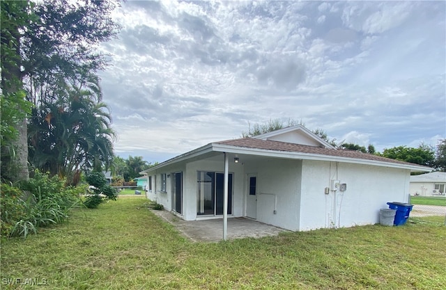 rear view of property with a patio area and a yard