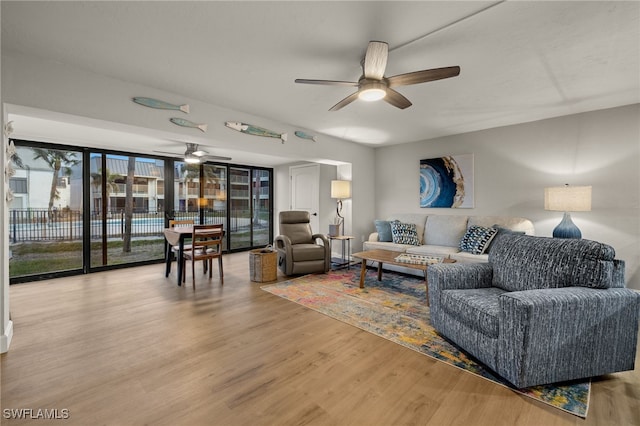 living room featuring floor to ceiling windows, hardwood / wood-style flooring, and ceiling fan