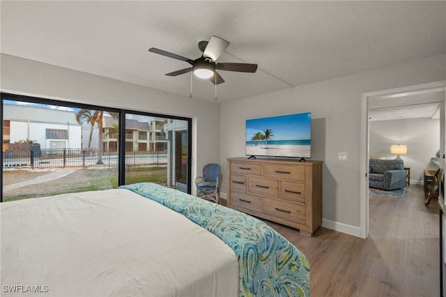 bedroom featuring ceiling fan, light hardwood / wood-style floors, and access to exterior