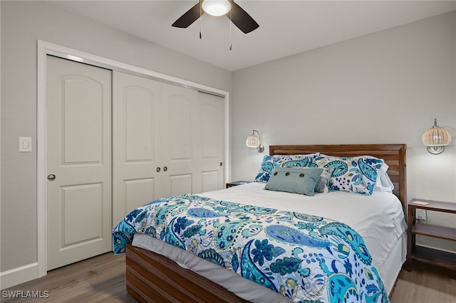 bedroom featuring ceiling fan, a closet, and hardwood / wood-style flooring