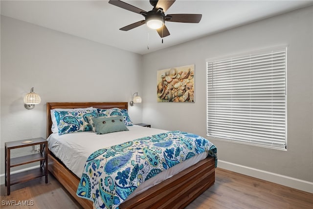 bedroom featuring hardwood / wood-style floors and ceiling fan