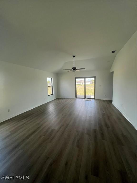 unfurnished living room featuring ceiling fan, lofted ceiling, and dark hardwood / wood-style flooring