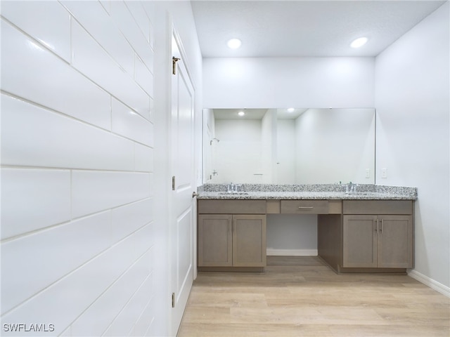 bathroom featuring hardwood / wood-style flooring and double vanity