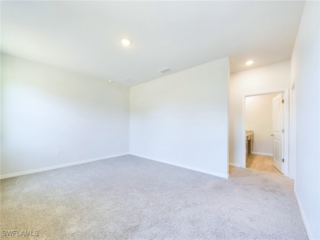 spare room with light carpet