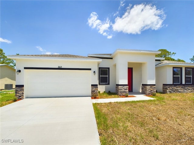 1057 Presque Isle Dr, Port Charlotte, FL 33952 - prairie-style home with stone siding, concrete driveway, stucco siding, an attached garage, and central AC