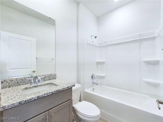 full bathroom featuring toilet, washtub / shower combination, and vanity