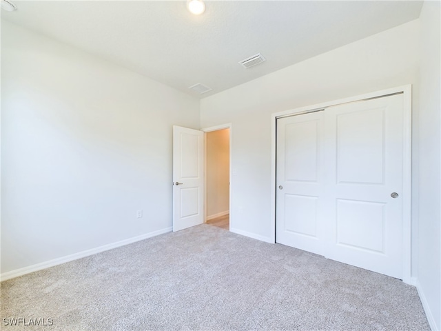 unfurnished bedroom with carpet and a closet