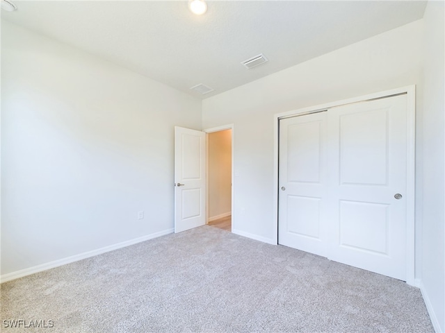 1057 Presque Isle Dr, Port Charlotte, FL 33952 - unfurnished bedroom with visible vents, carpet, a closet, and baseboards