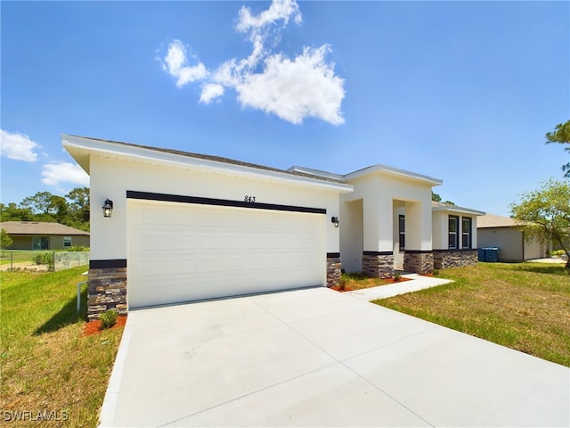 1057 Presque Isle Dr, Port Charlotte, FL 33952 - prairie-style home featuring stone siding, an attached garage, stucco siding, a front lawn, and driveway