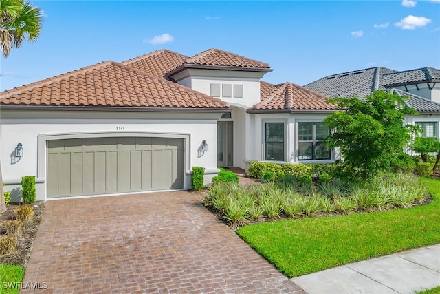 mediterranean / spanish-style home featuring a garage