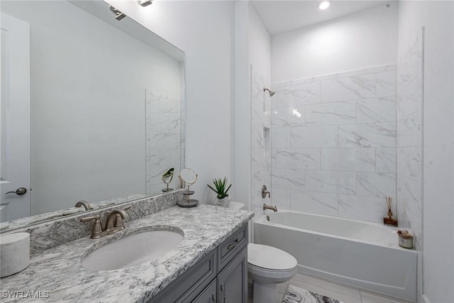 bathroom featuring toilet, vanity, and shower / bathing tub combination