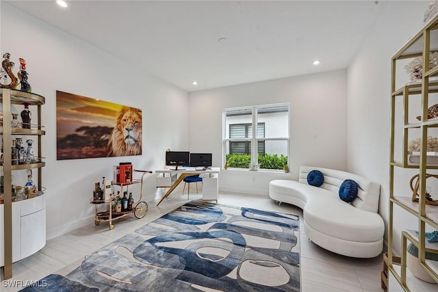 living area featuring recessed lighting and baseboards