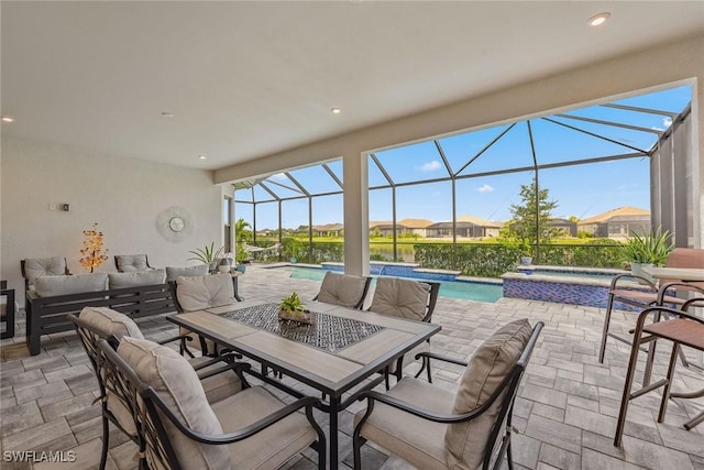 view of patio featuring outdoor dining space, glass enclosure, outdoor lounge area, and a pool with connected hot tub